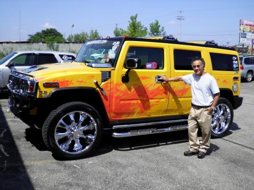 Yellow Hummer with flame decal on the side
