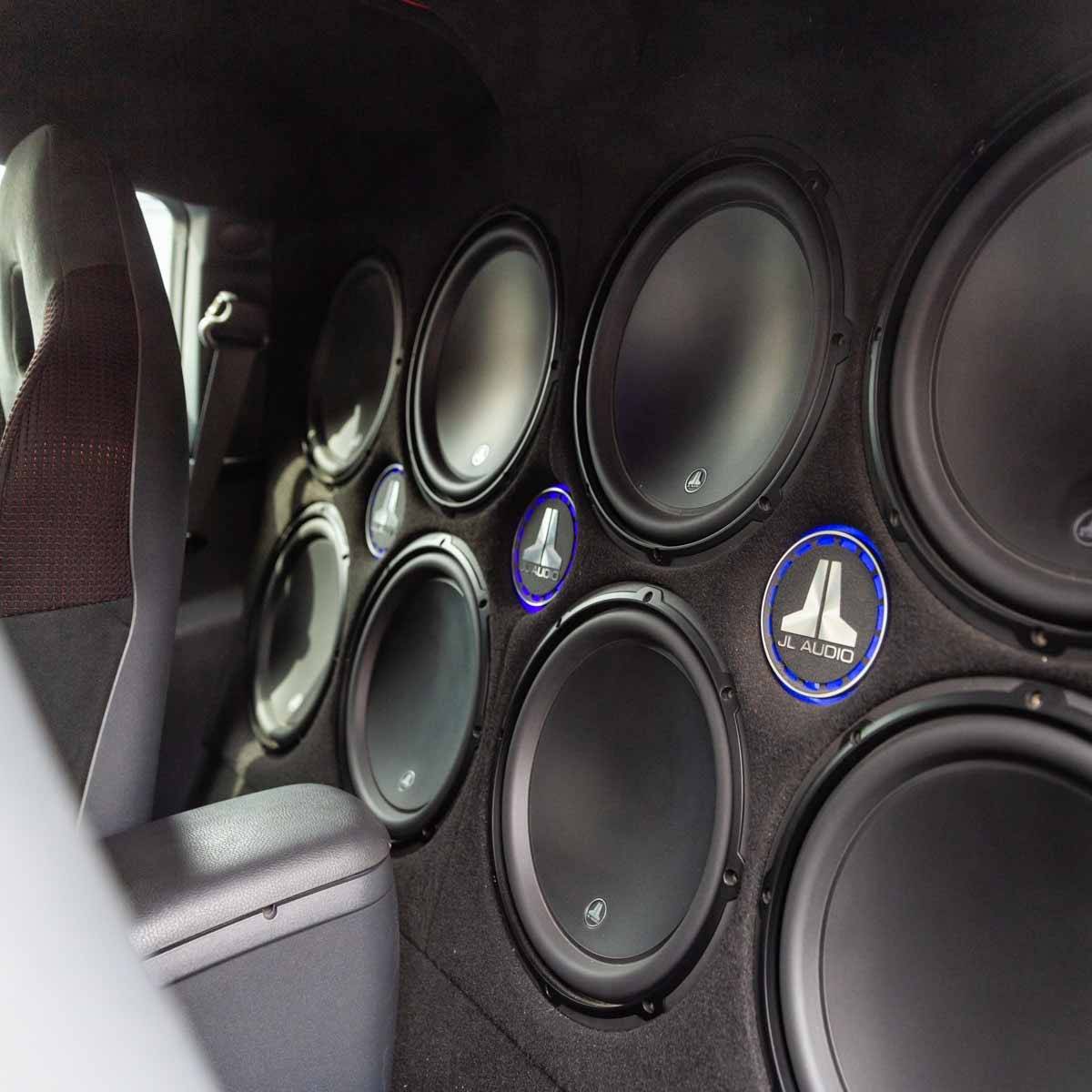 A wall of speakers in the back of a car